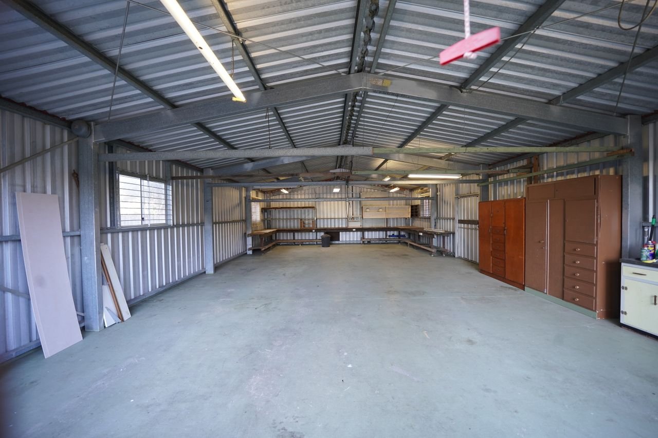 pexels photo 12771396 12771396 Empty industrial garage with metal walls and concrete floor ready for renovation or use.